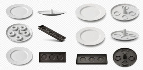 Set of various white and black ceramic fondue plates and trays with compartments for sauces and food.