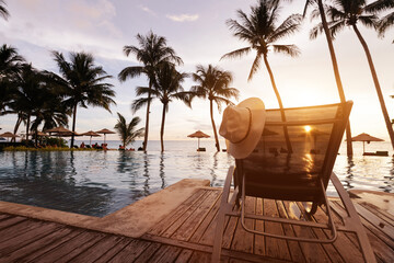 beach vacation in luxury hotel, tropical holiday travel and tourism, hat on deckchair