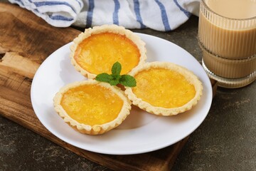 Traditional custard tart known as pie susu, featuring creamy filling and pastry crust, popular Asian dessert and bakery item.