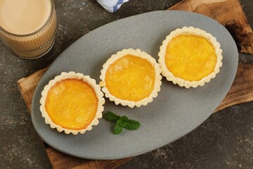 Traditional pie susu custard tarts arranged neatly, highlighting Asian bakery dessert with creamy texture and golden crust.
