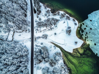 Winter magic in the Julian Alps. Lake Predil seen from above. Between snow and ice.