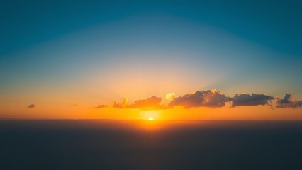 wholeness. Golden sunrise over a calm horizon, first light on clouds, serene landscape with deep blue sky. travel magazines, destination branding, designed for outdoor magazines and nature guides.
