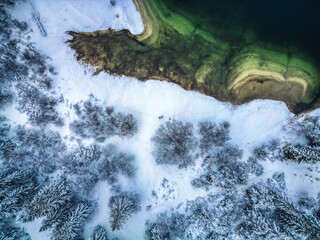 Winter magic in the Julian Alps. Lake Predil seen from above. Between snow and ice.