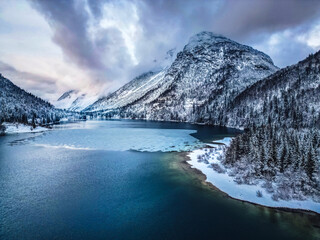 Winter magic in the Julian Alps. Lake Predil seen from above. Between snow and ice.