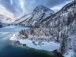 Winter magic in the Julian Alps. Lake Predil seen from above. Between snow and ice.