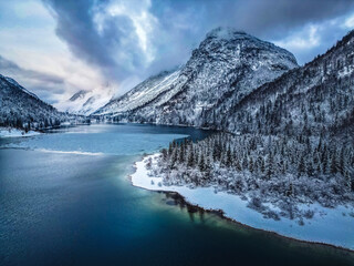 Winter magic in the Julian Alps. Lake Predil seen from above. Between snow and ice.