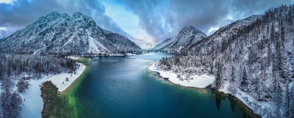 Winter magic in the Julian Alps. Lake Predil seen from above. Between snow and ice.