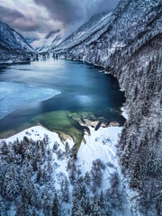 Winter magic in the Julian Alps. Lake Predil seen from above. Between snow and ice.
