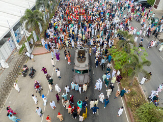 Aerial view of a military vehicle moving through a densely packed street with people, Dhaka, Dhaka Division, Bangladesh.