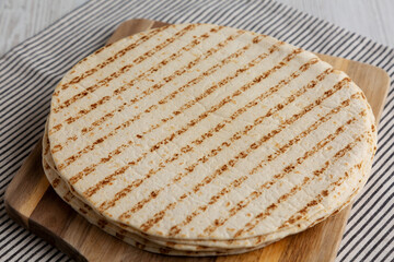 Homemade Grilled Flour Tortillas in a Stack, side view. Close-up.