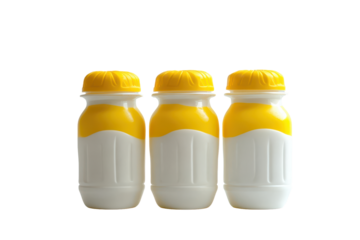 Small plastic bottles with yellow caps and milk isolated on transparent background. Milk cheese yogurt bottles dairy healthy isolated on white background.
