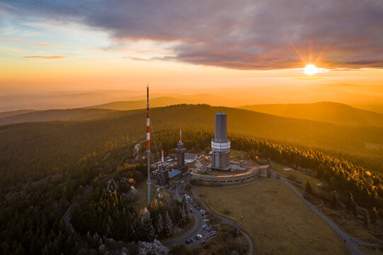 Aerial view of the Grosser Feldberg broadcasting tower bathed in the warm glow of the setting sun, Schmitten im Taunus, Hessen, Germany.