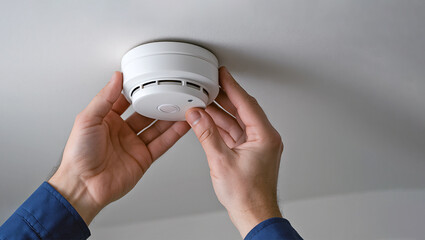Technician installing a smoke alarm on the ceiling, professional home safety service scene highlighting fire prevention, residential security, and modern safety standards.