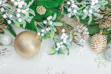 Traditional New Year composition. Festive decor, snowy Christmas tree branches, balls, flowers