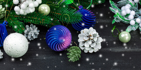 Happy New Year background. Festive Christmas baubles, evergreen branches, pine cones, snowy berries