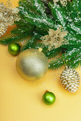 Traditional New Year composition. Festive decor, snowy Christmas tree branches, balls, flowers