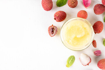Homemade Lychee jam marmalade in jar, with fresh ripe lychees fruits on white table background, copy space