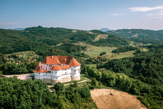 Aerial view of the majestic Veliki Tabor castle with its red roofs contrasting against the surrounding lush green hills, Hum Kosnicki, Krapinsko-zagorska zupanija, Croatia.