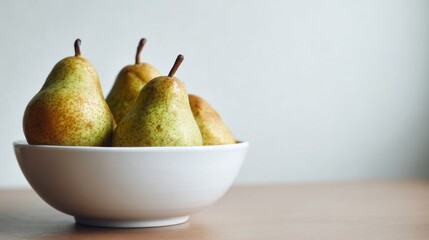 Fresh pears in a white bowl on table