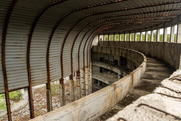 View of the skeletal remains of an abandoned building reveal its curved structure and decaying concrete in Perla 2, Primorsko, Bulgaria.