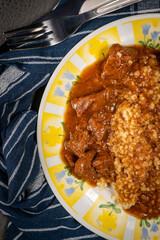 Beef goulash served with bulgur groats.