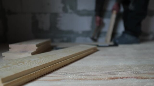 Precision fitting of wooden floorboard during home renovation