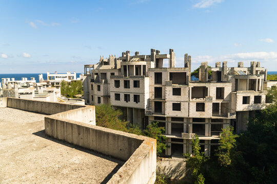 View of decaying concrete structures rise against the azure sea, a stark contrast of abandonment and nature's beauty, Costa del croco, Tsarevo, Bulgaria.