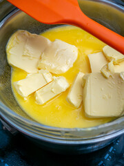 Melting Butter in Bowl: Double Boiler Method for Butter Preparation Cooking Process Infusion Close-up