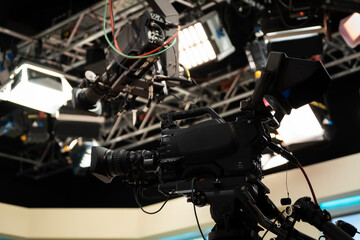 Professional broadcasting studio featuring high-end camera equipment, jib crane on a truss system, and powerful led lighting for television production and media recording