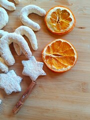 Fresh homemade holiday cookies with sugar powder, dry oranges and spices, Christmas cookie background