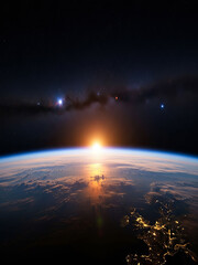 Sunrise over Earth from space with stars and galaxy
