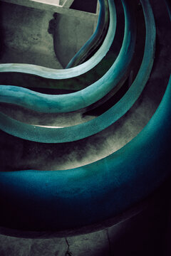 View of winding, vibrant blue and turquoise lines contrast against a dark, textured background, creating a mesmerizing abstract composition, Crevarska Strana, Sisak-Moslavina County, Croatia.