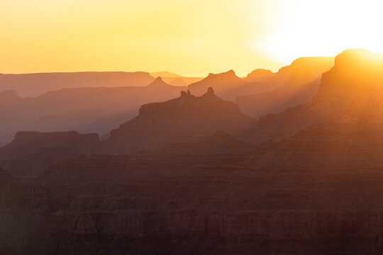 Golden sunrise over desert canyon formations Grand Canyon National Park