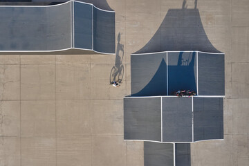 Biker performing tricks in a urban skatepark with ramps and shadows