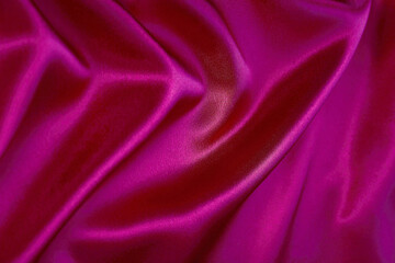 Vibrant magenta satin fabric texture with glossy folds, luxury silk background ideal for bold fashion design, beauty themes, glamorous branding, decor.