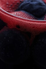 close up of bubbles red wine