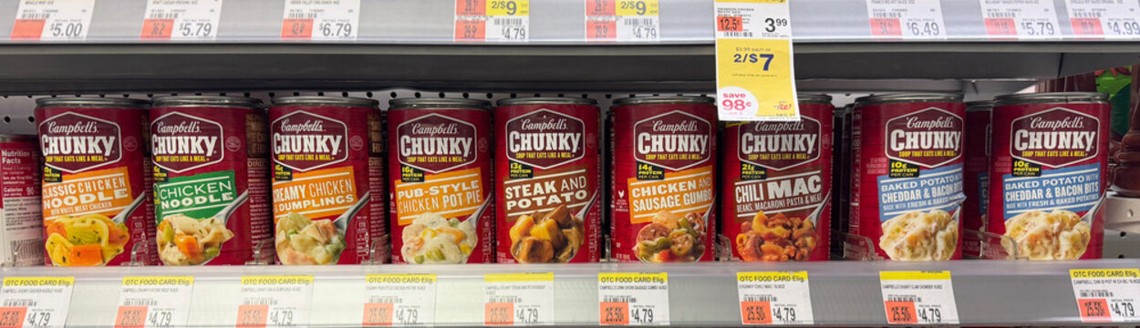 Assortment of Campbell's Chunky canned soups on sale at a Walgreens drug store.