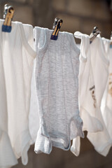 Baby bodysuit hanging on a clothesline