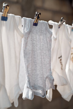 Baby bodysuit hanging on a clothesline