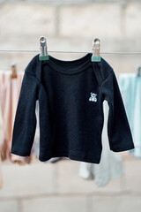 Baby sweater hanging on a clothesline