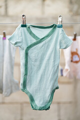 Striped baby bodysuit hanging