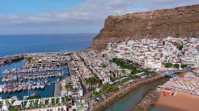 Puerto de Mogan, Gran Canaria, Canary Islands, Spain: Aerial view of marina in famous tourist resort, summer sunny day - landscape panorama of Atlantic Ocean islands from above
