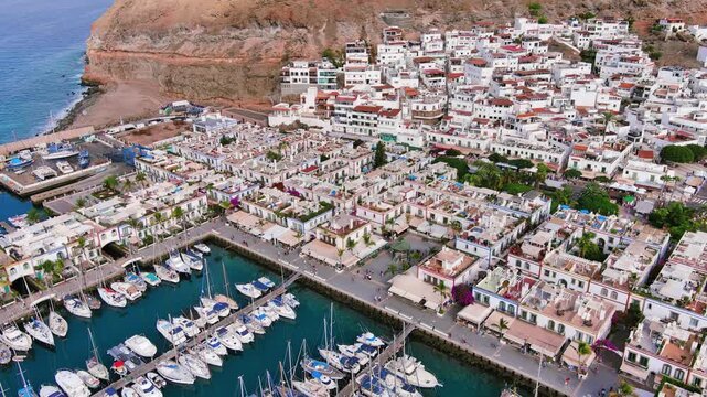 Puerto de Mogan, Gran Canaria, Canary Islands, Spain: Aerial view of marina in famous tourist resort, summer sunny day - landscape panorama of Atlantic Ocean islands from above
