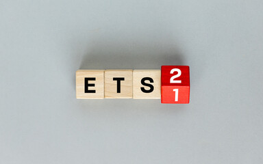 ETS 2 European Trading System. Business and environmental concept. ETS on wooden blocks and the number one changing to two. New System for Trading in CO2 Emission Permits. Growing Cost of Fossil Fuels