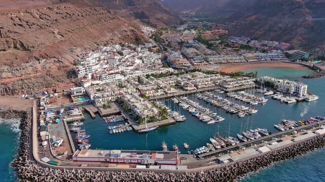 Puerto de Mogan, Gran Canaria, Canary Islands, Spain: Aerial view of marina in famous tourist resort, summer sunny day - landscape panorama of Atlantic Ocean islands from above
