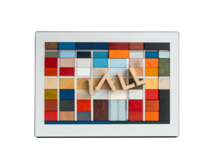Framed artwork of 3D wooden letters on a colorful block grid