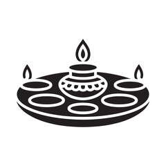 A simple black and white illustration of a traditional diya lamp with offerings