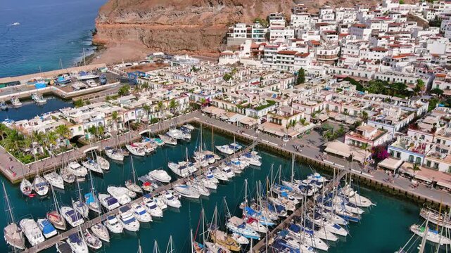Puerto de Mogan, Gran Canaria, Canary Islands, Spain: Aerial view of marina in famous tourist resort, summer sunny day - landscape panorama of Atlantic Ocean islands from above
