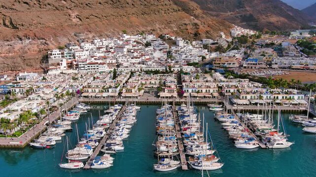 Puerto de Mogan, Gran Canaria, Canary Islands, Spain: Aerial view of marina in famous tourist resort, summer sunny day - landscape panorama of Atlantic Ocean islands from above
