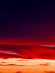 Fototapeta premium Sunset sky with dramatic streaked clouds and vibrant red-orange-purple hues – ideal nature background for commercial use Abstract Gradient Backdrop